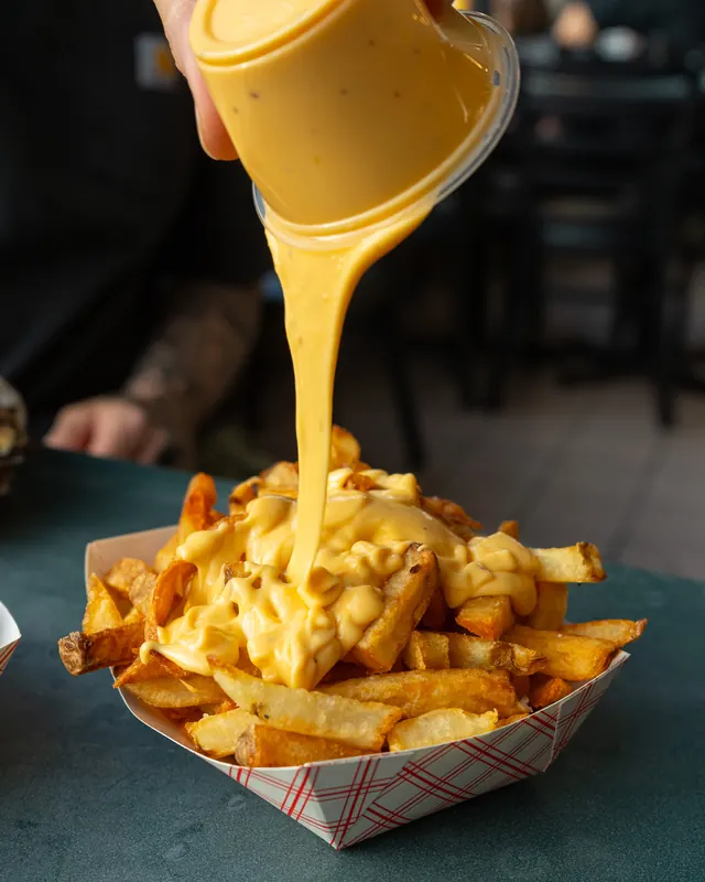 Cheese sauce poured over hand-cut fries