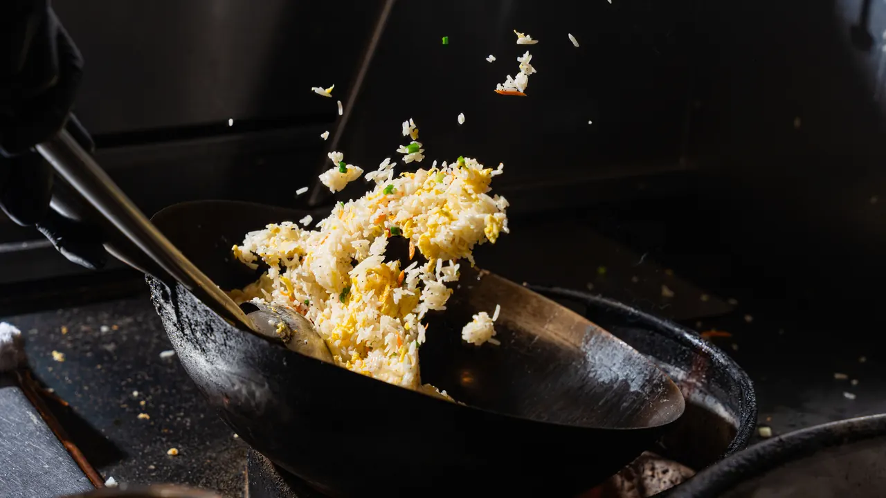 Fried rice tossed high out of a wok