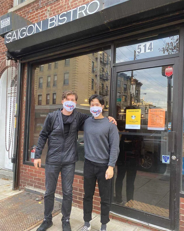 Ryan and Zi in masks outside the new storefront